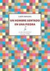 UN HOMBRE SENTADO EN UNA PIEDRA